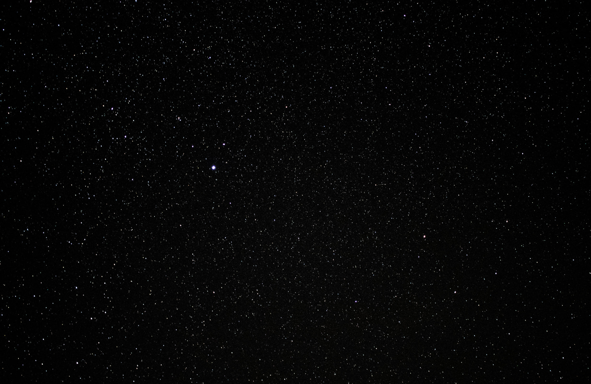 A clear night sky filled with a dense field of distant stars